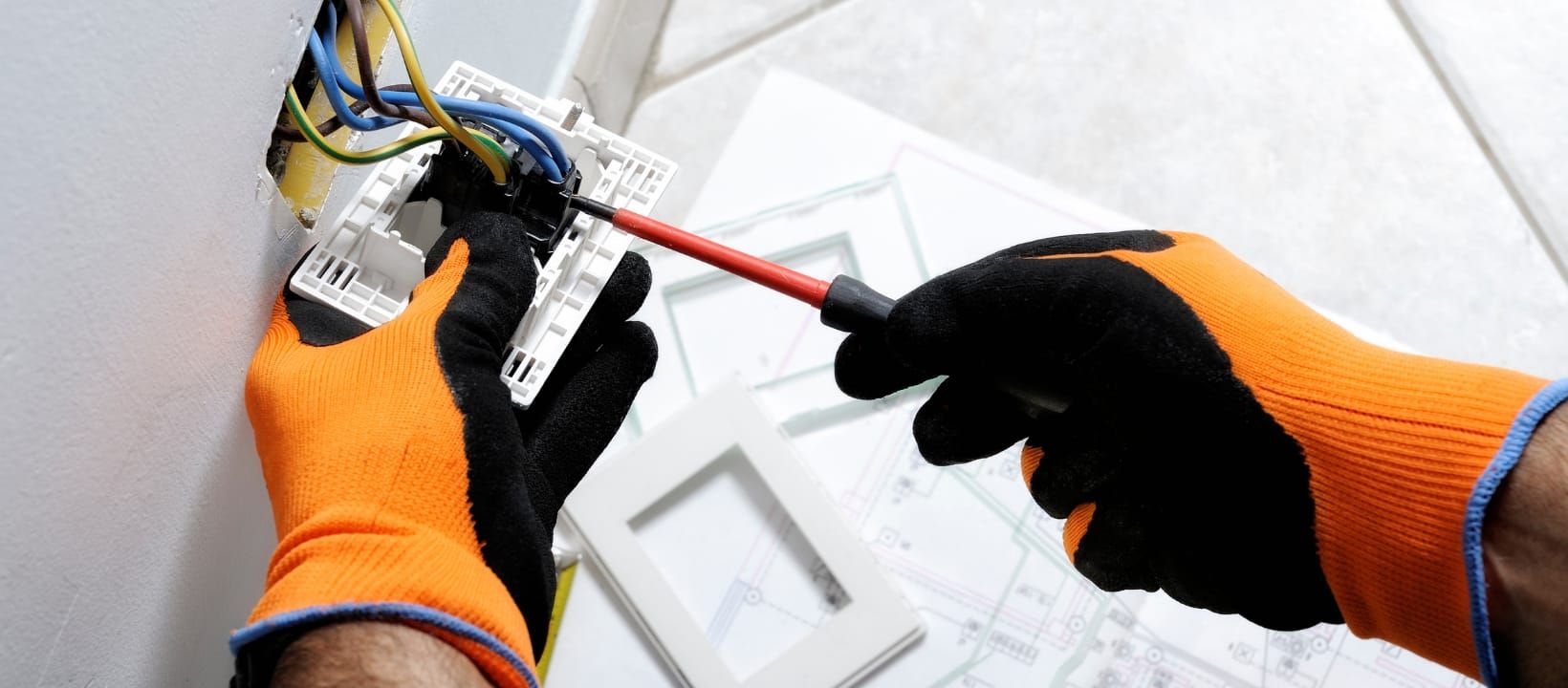 An electrician wiring an outlet.